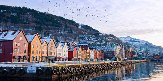 colorful houses with snow on rooftop in bergen, norway