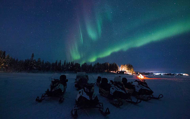 aurora borealis expedition on snowmobile in sweden