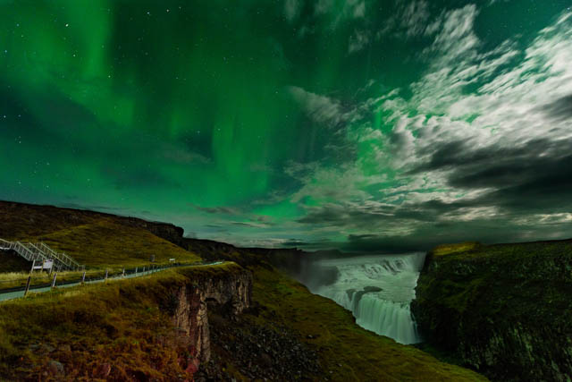 northern lights over gullfoss waterfall in iceland