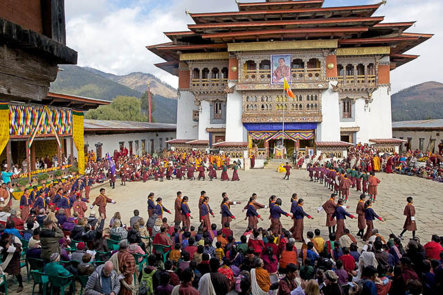 marching ceremony at gangtey monastery with bhutanese people in traditional clothes