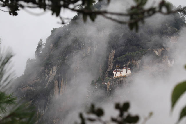 one side of tiger's nest monastery seen amidst the fog