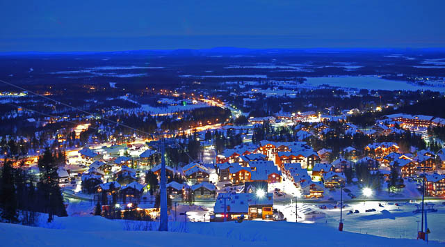 lights lit up at night in a snow covered village in kittila finland