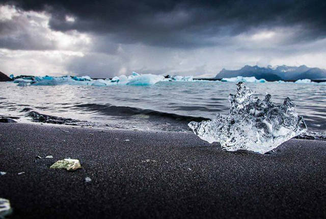 ice rocks on black sand beach at jokulsarlon iceland