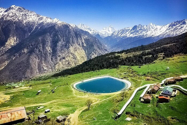 snow capped mountains and aerial views of chenab lake in auli uttarakhand india