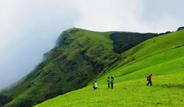 people on one of Chikmagalur green hills Karnataka India