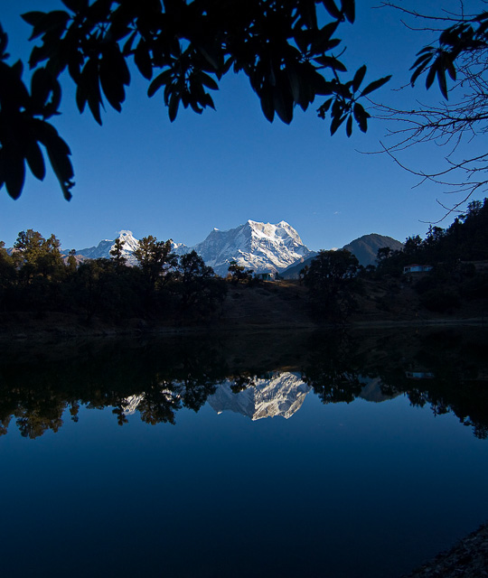 blue sky snow capped mountain reflection on a lake chopta uttarakhand india