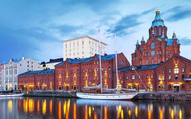 boats docked on a waterbody near helsinki city buildings