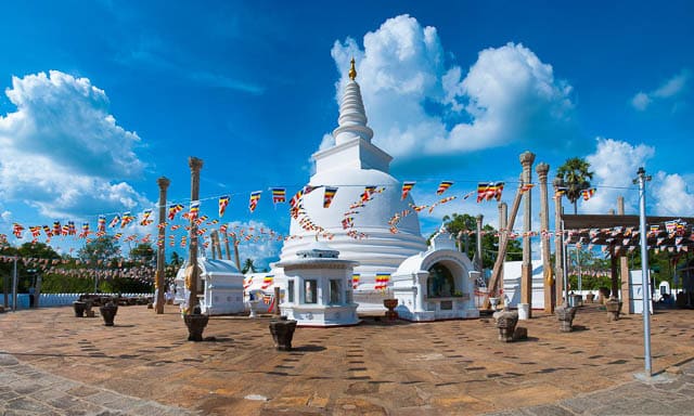 blue sky with clouds over thuparamaya dagoba in anuradhapura, sri lanka